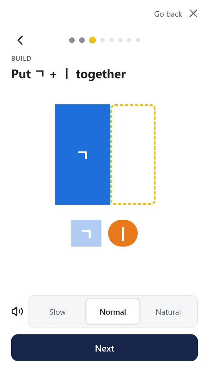 Build step: putting two letter pieces together, with the first piece already placed in the left slot